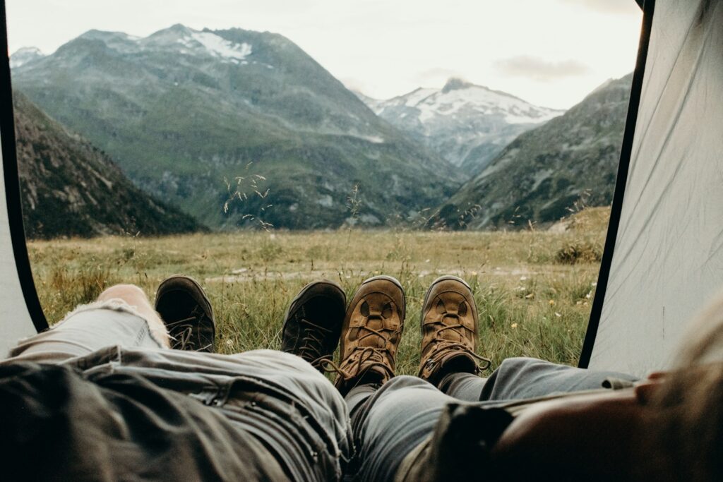 two person lying on tent