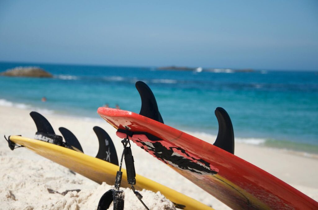 Colorful surfboards resting on a sunny beach in Brazil, ideal for surf enthusiasts.