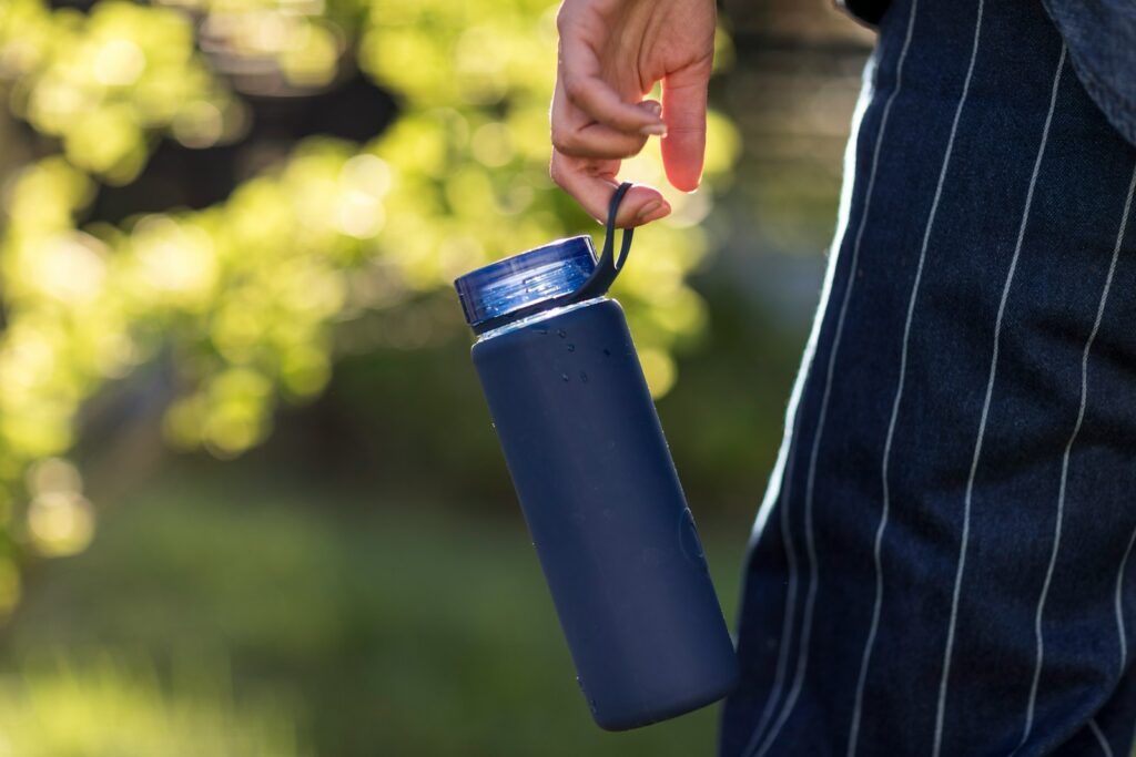 person holding blue plastic cup