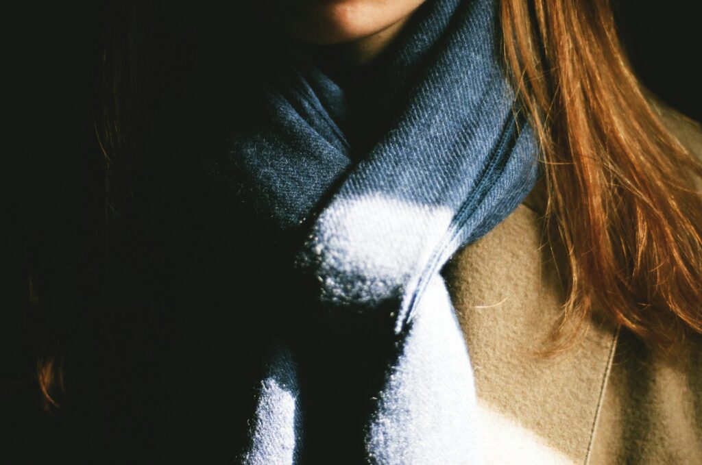 woman wearing brown top and black scarf