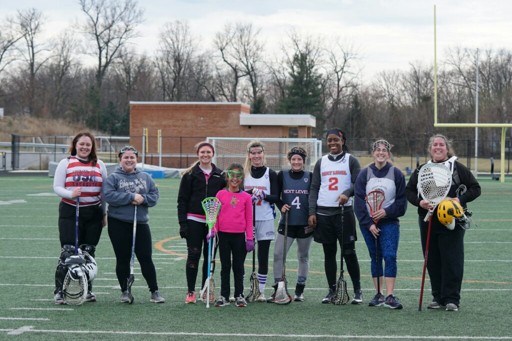 people standing on american football field