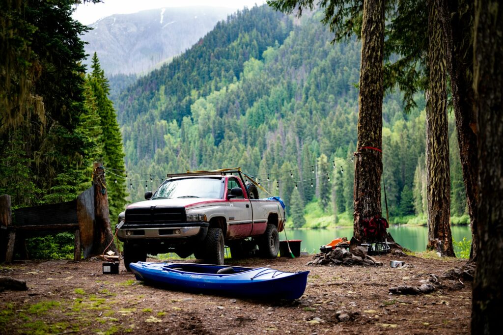 A pick up truck parked next to a canoe