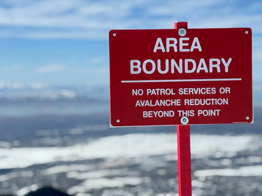 An area boundary sign warns of avalanche danger.