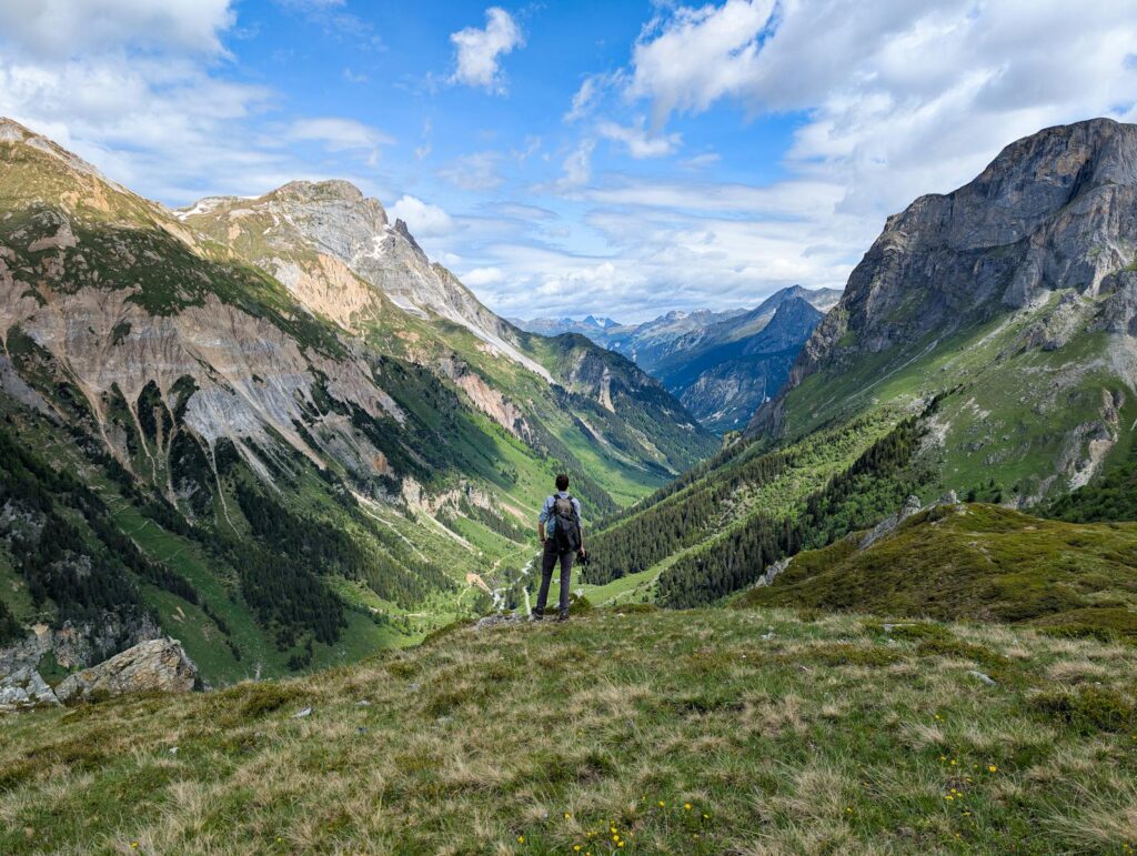 A hiker stands in awe of the scenic Vanoise National Park in France.