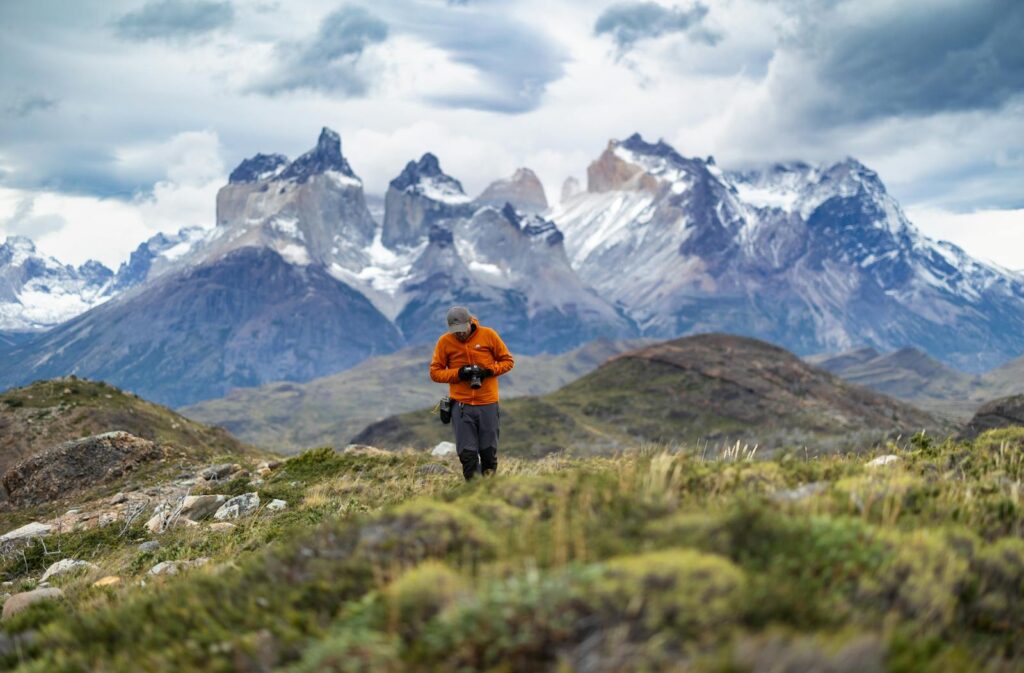 A lone photographer captures the breathtaking mountains of Torres del Paine in Chile.