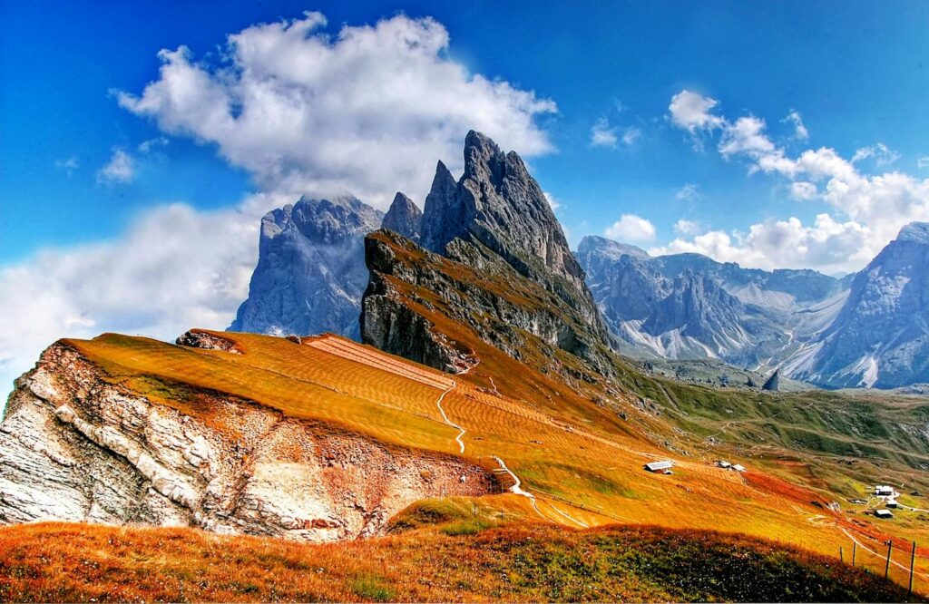 Breathtaking view of the Dolomites with vibrant autumn colors and crisp skies.