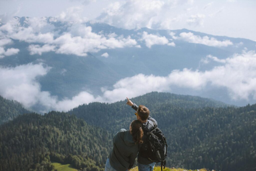 Couple hiking in mountains, embracing nature and adventure.