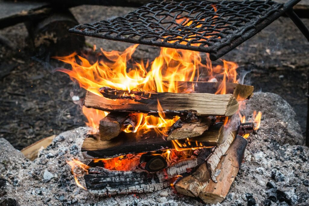 closeup photography of firewood under black metal chain