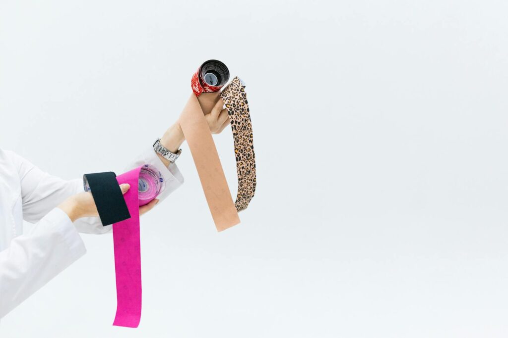 Vibrant assortment of kinesiology tape rolls held by a doctor, great for medical themes.