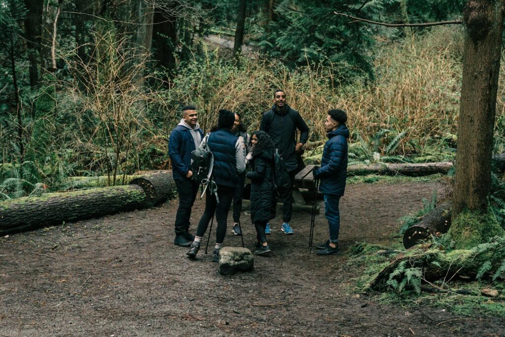 A group of friends enjoy a hiking trip in a lush forest, perfect for outdoor leisure.