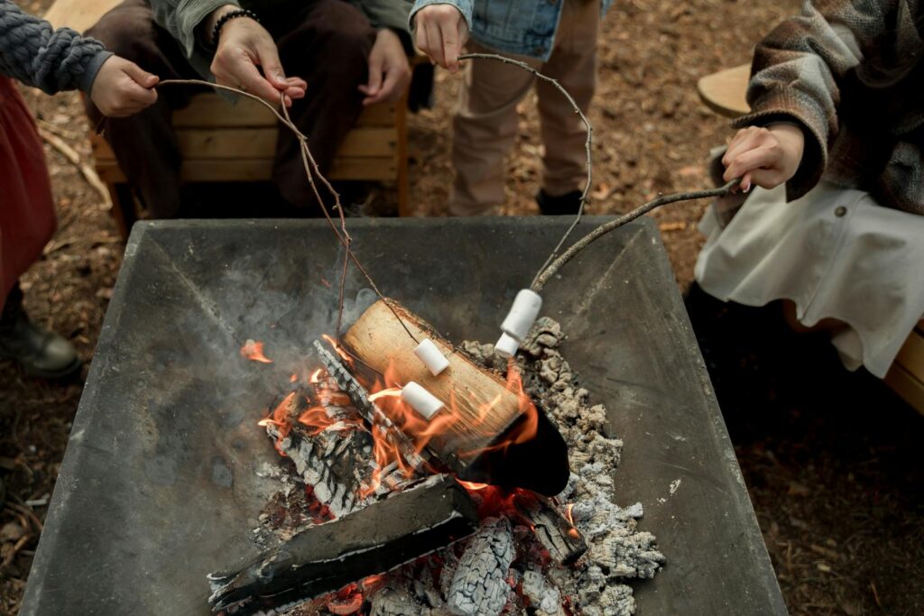 Campers enjoy roasting marshmallows over a warm campfire, perfect for an outdoor adventure.