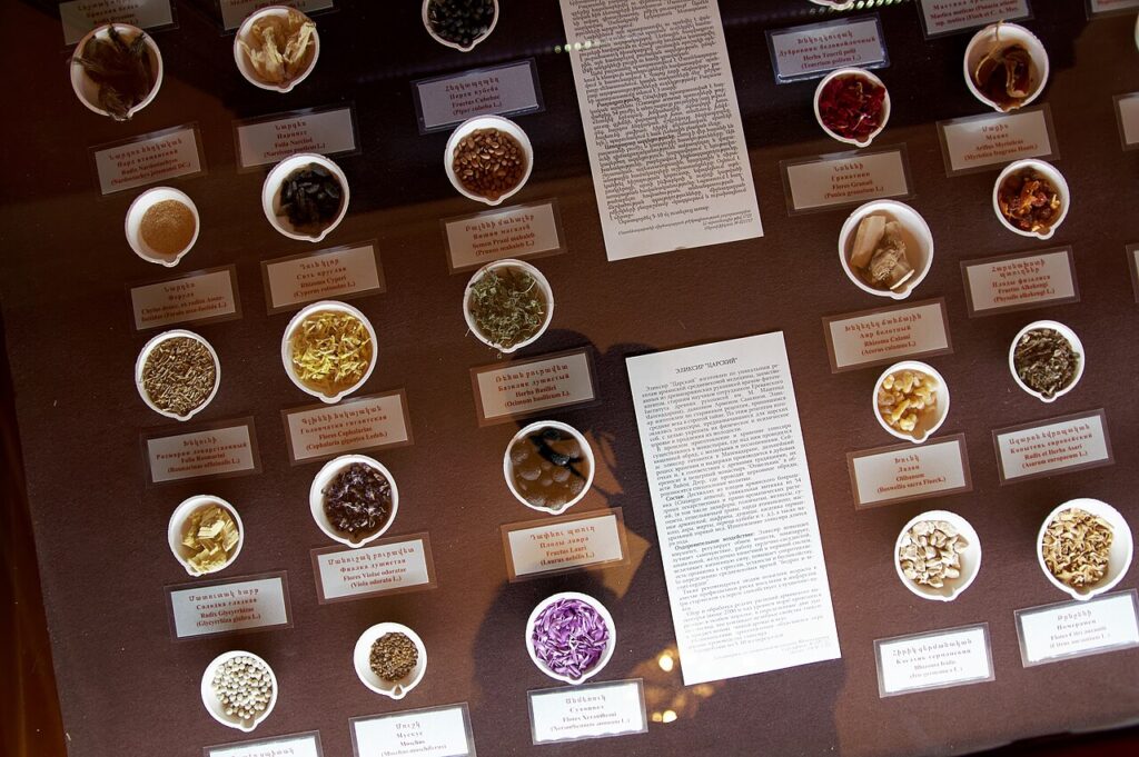 An array of various herbs and spices displayed in small bowls, labeled with names and descriptions, alongside an informational text.