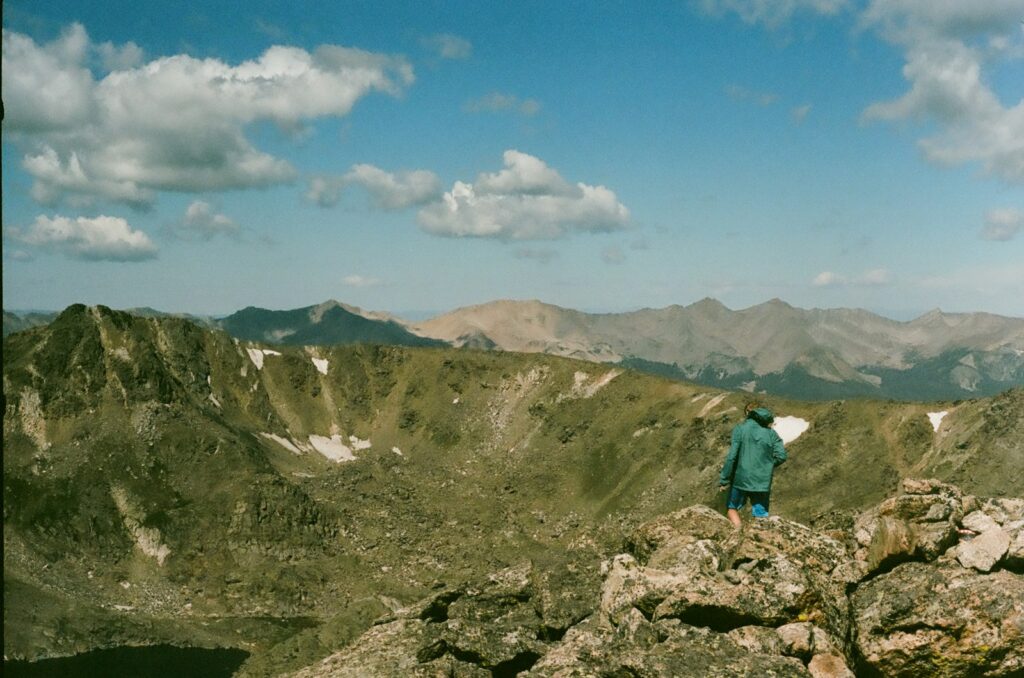 A man standing on top of a rocky mountain