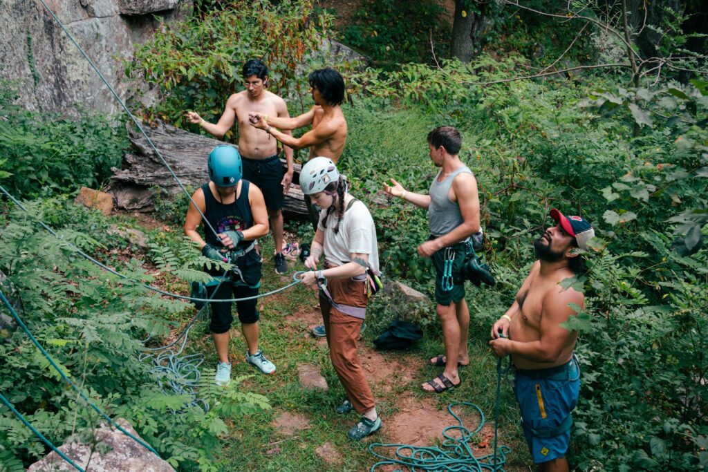 A group of men standing on top of a lush green hillside