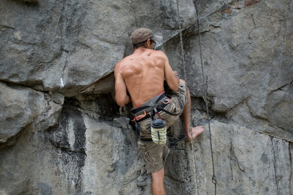 a man climbing up the side of a mountain