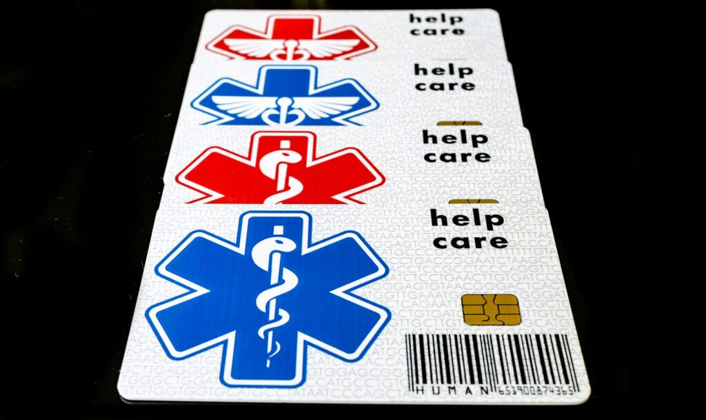 A series of three cards featuring medical symbols in red, blue, and white, with "help care" text and a barcode on a black background.