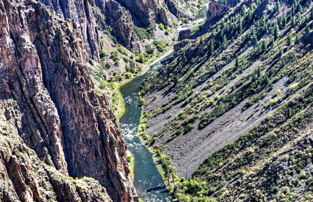 a river running through a canyon surrounded by mountains