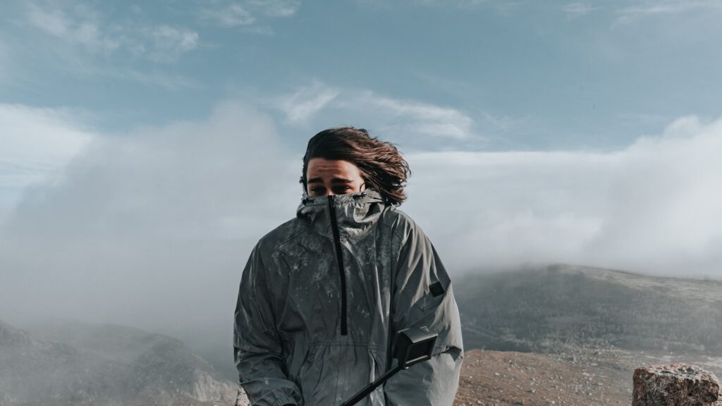a man with a backpack on a mountain