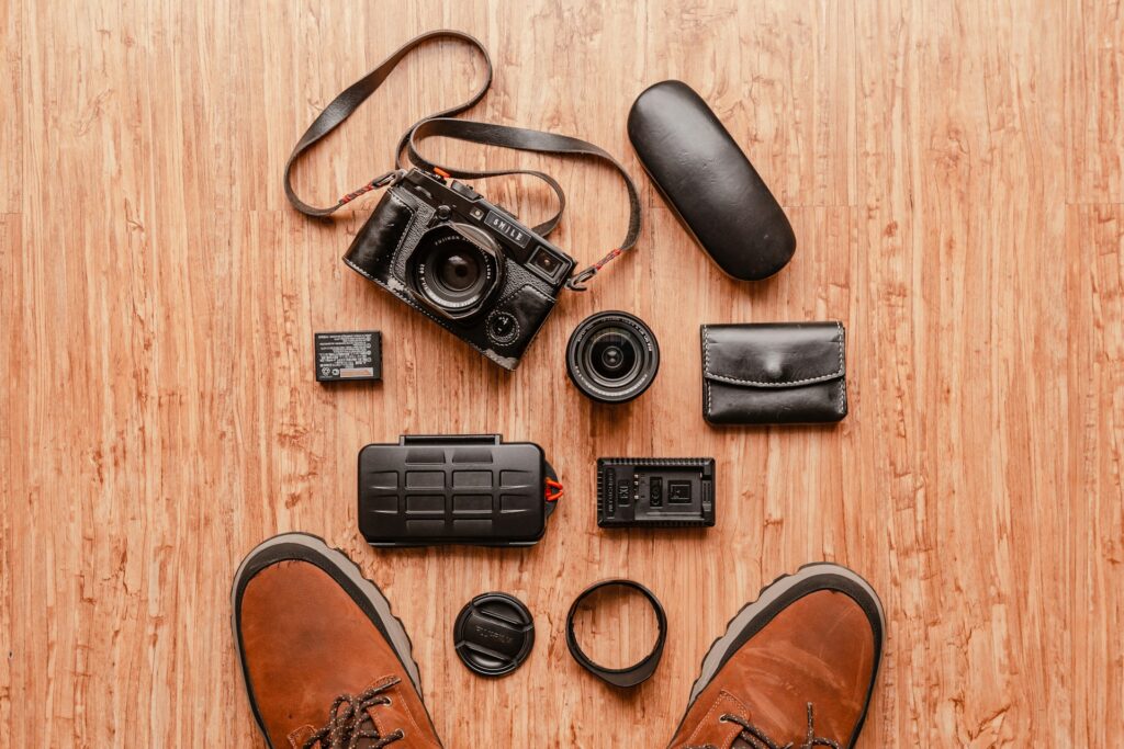 A person's feet are surrounded by various colorful items, including shoes, books, and small decorative objects.