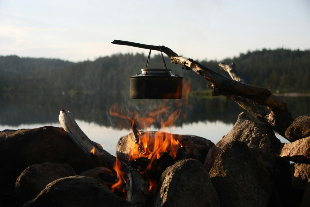 a campfire with a pot hanging over it