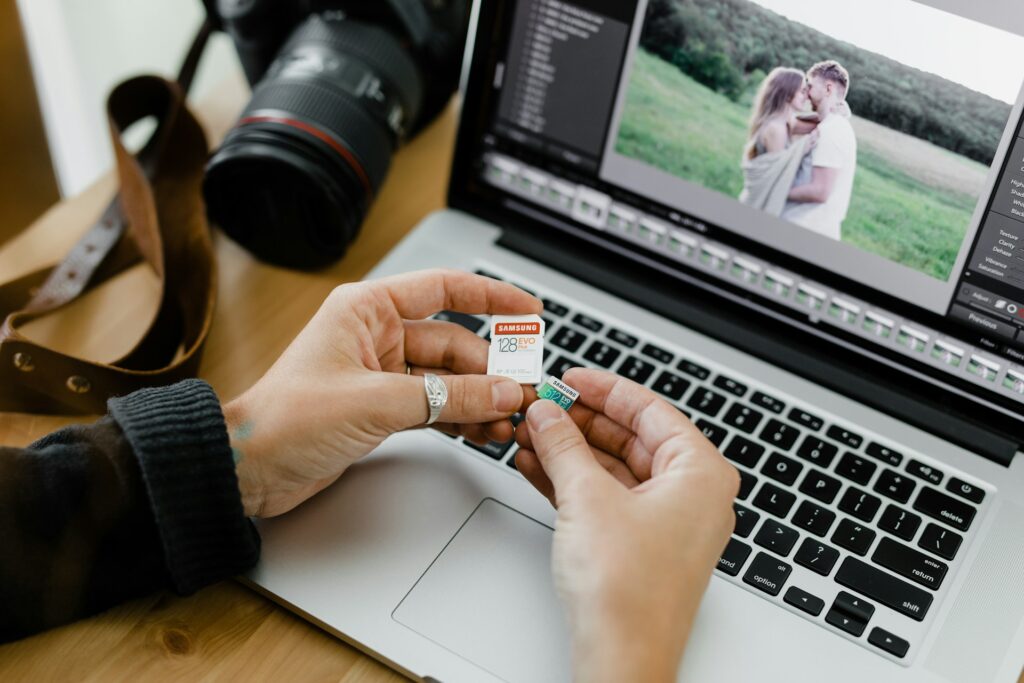 A person holding a camera in one hand and a flash drive in the other, ready to capture and store images.