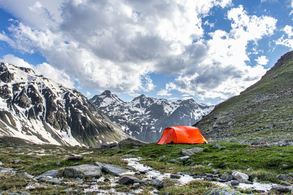 A tent is pitched up on a rocky mountain