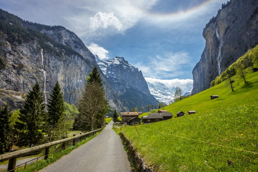 road near green hill during daytime