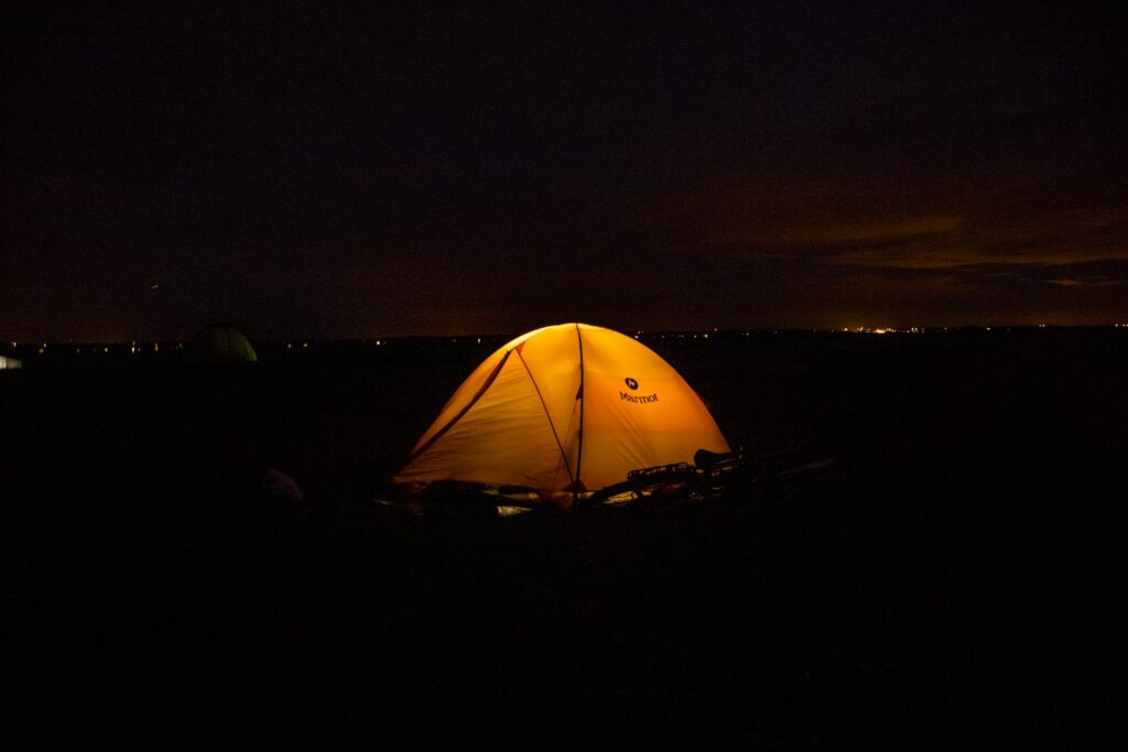 a tent is lit up in the dark