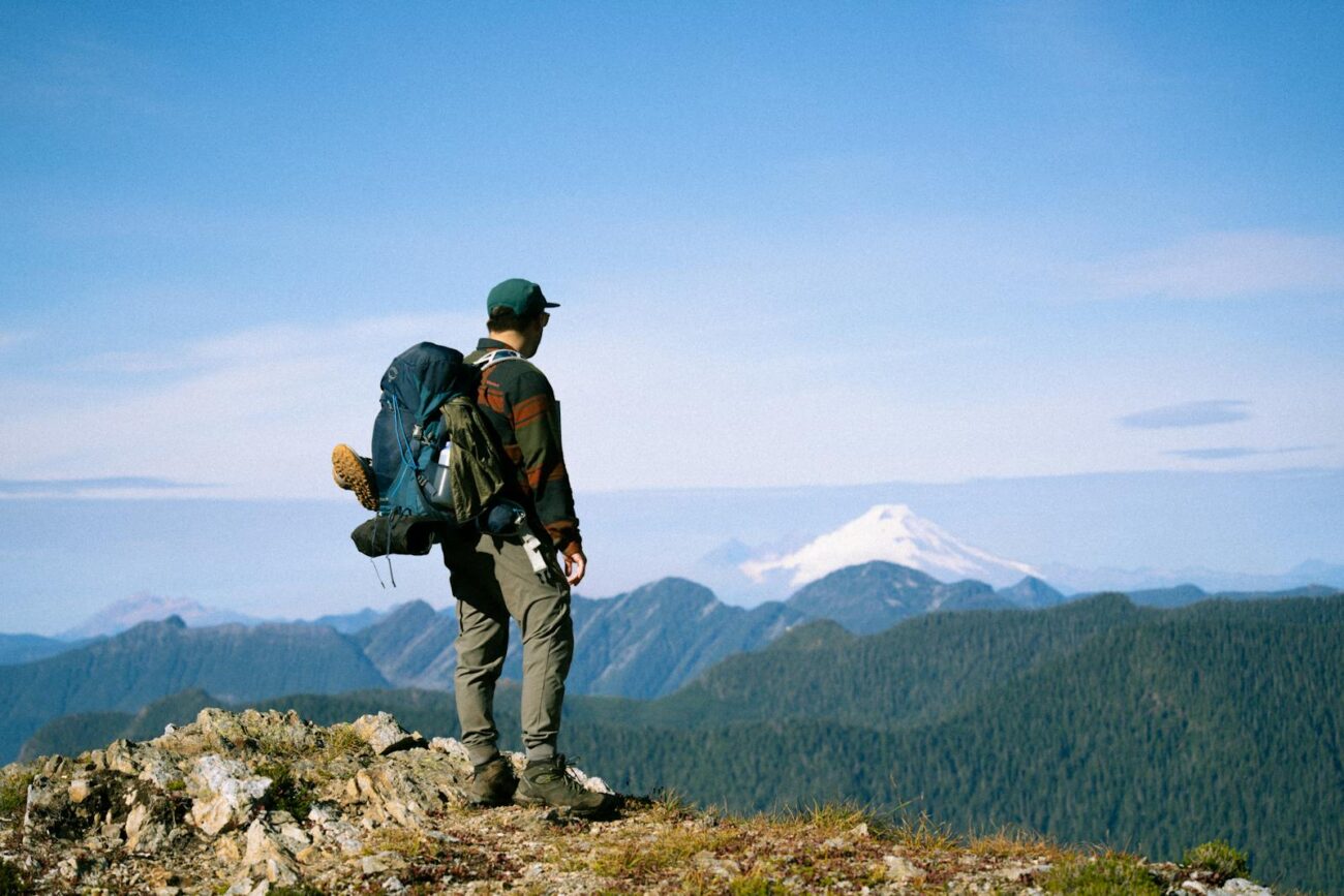Hiker enjoying a breathtaking view of Mt. Baker in Washington, perfect for travel and adventure themes.