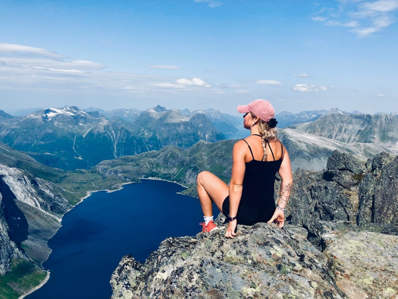 woman sitting on mountain cliff