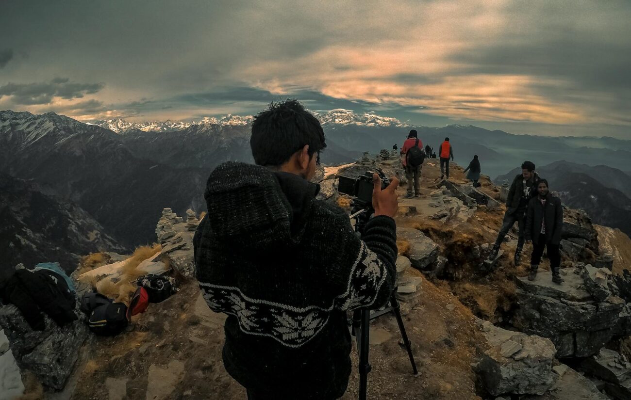 Hikers capture the breathtaking view at a mountain peak during a scenic trekking adventure.