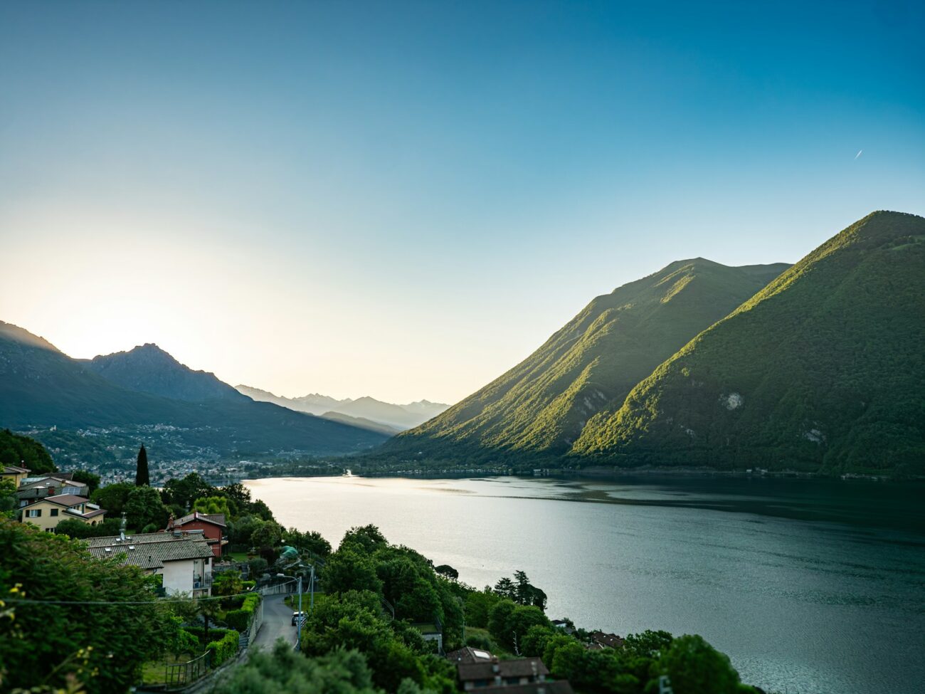 a scenic view of a lake surrounded by mountains